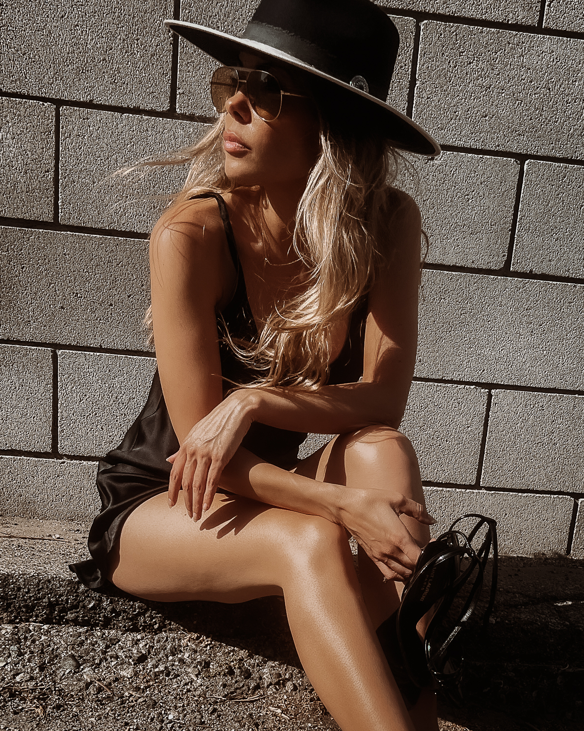 ryan starr in flattering black slip dress and black hat