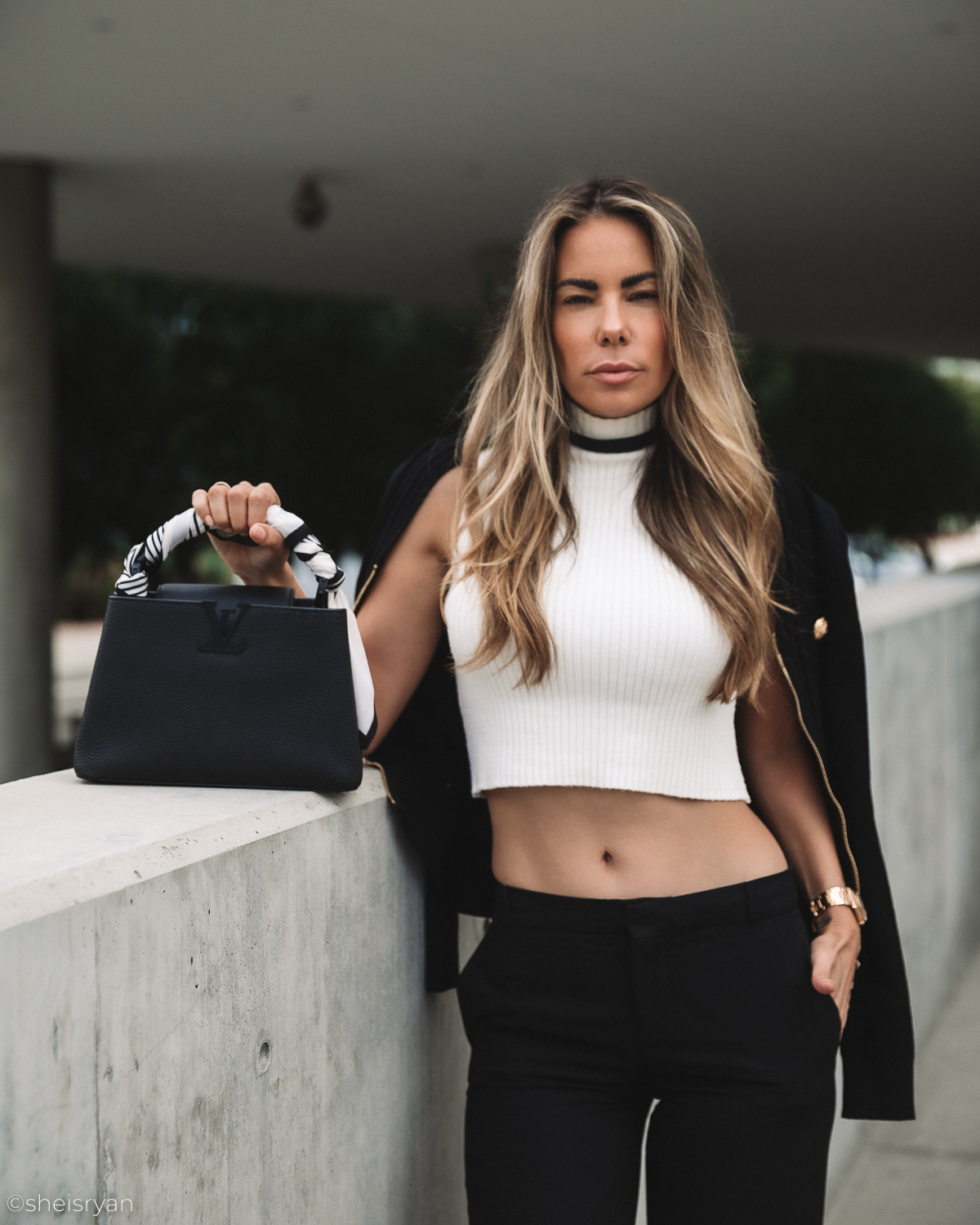 women with black handbag luxury accessories worth investing in 